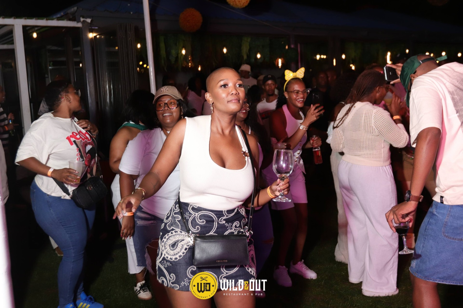 All-white garden party crowd dancing
