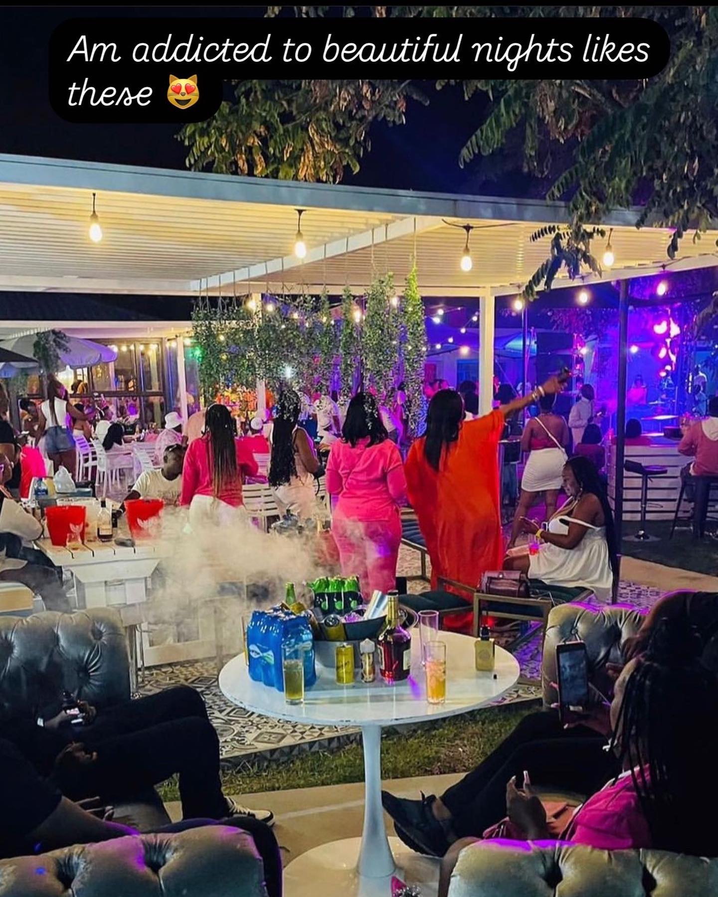 Outdoor lounge night with bottle service and neon lights
