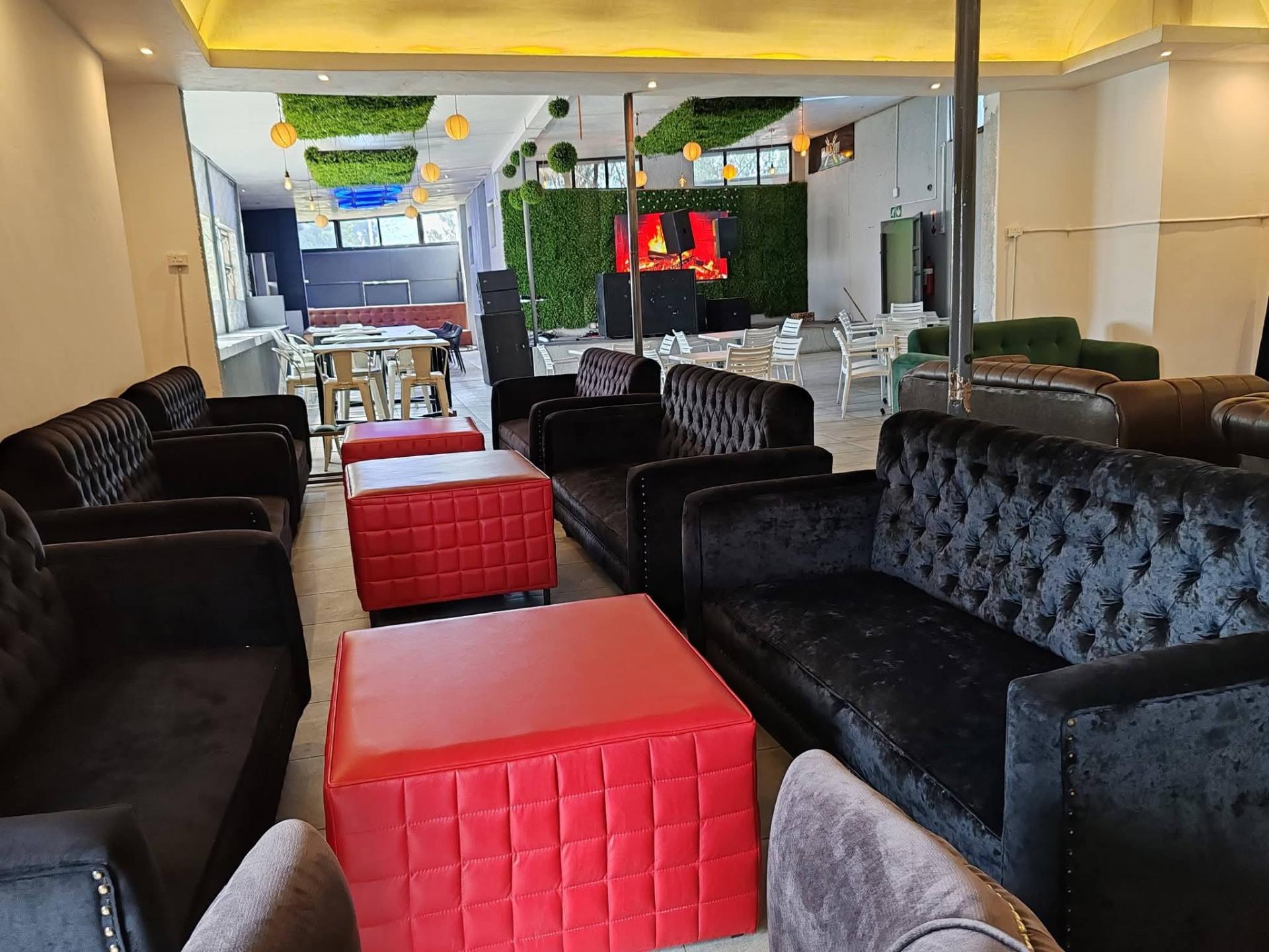 Lounge area with chesterfield sofas and fireplace screen